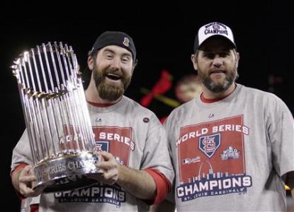 St. Louis Cardinals relief pitcher Jason Motte holds the World Seres trophy as he stands with Lance Berkman after they defeated the Texas Rangers in Game 7 of MLB's World Series baseball championship in St. Louis